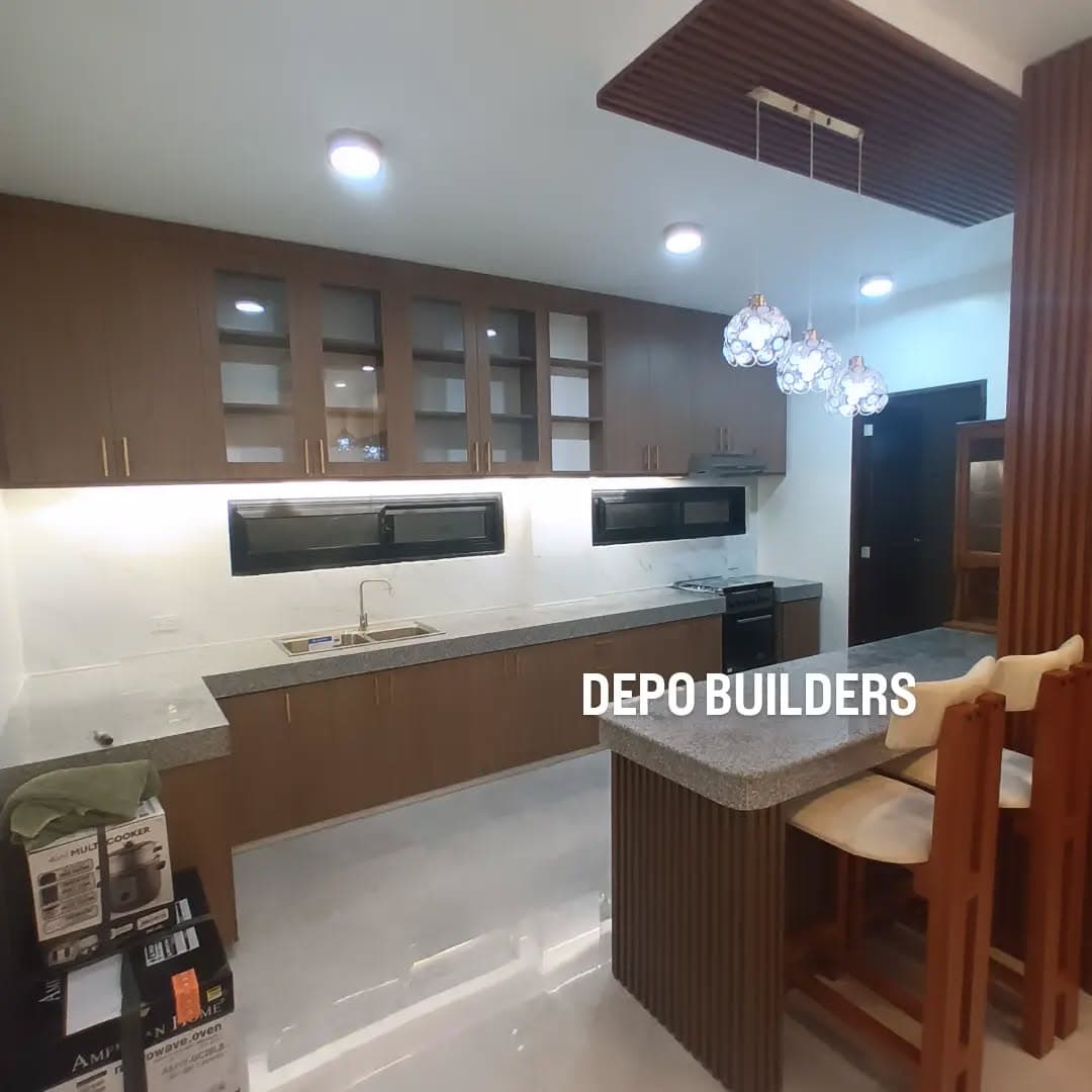 Modern kitchen with granite counters, glass-front cabinets, and a breakfast island