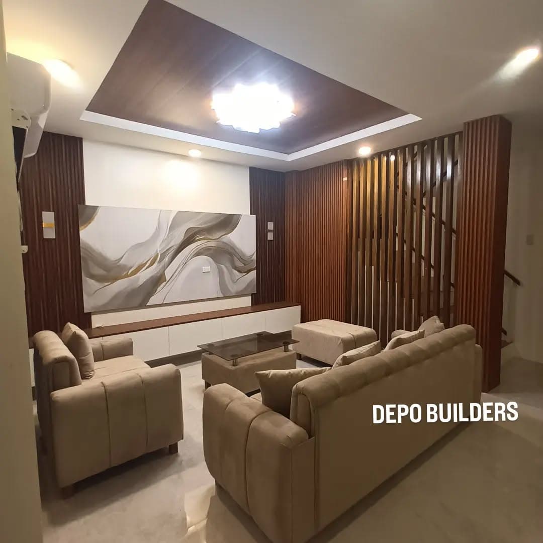 Living room with a wood slat feature wall, recessed ceiling, and sofa set